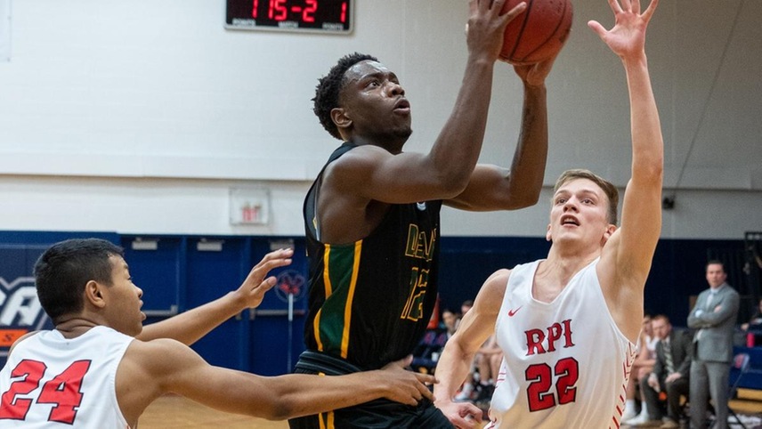 Darius Hines #12 splitting two defenders on his way to a drive toward the basket.
