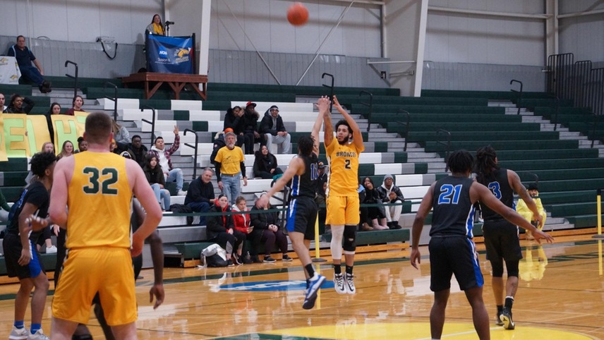 Justin Daoud #2 attempting a 3-pointer with a defender on him.