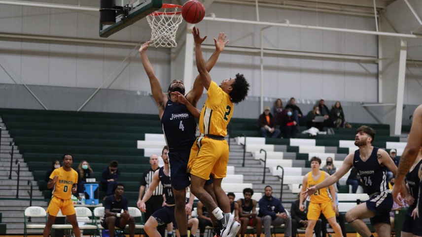 basketball player going up for a layup contested.