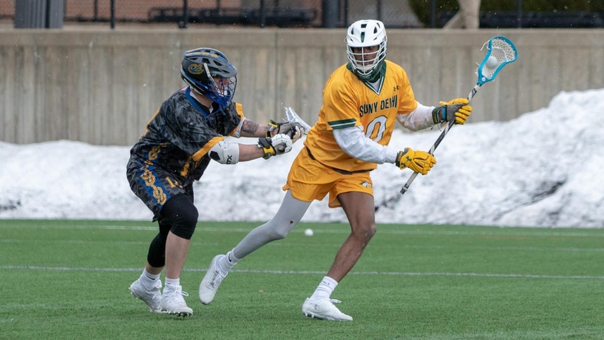 King White #0 ready to advance the ball up field with a defender on him.