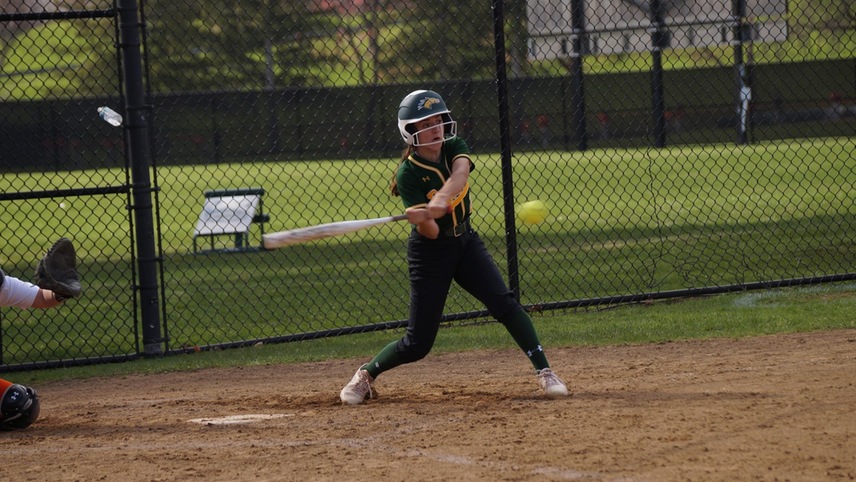 softball player hitting the ball
