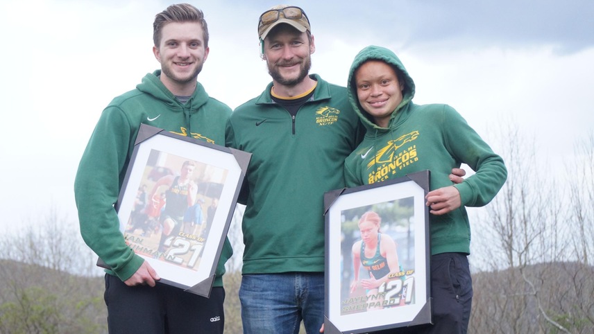 track athletes and coach posing for photo