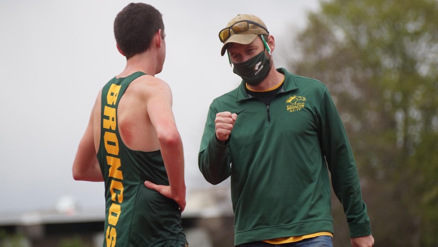 track coach talking to athlete
