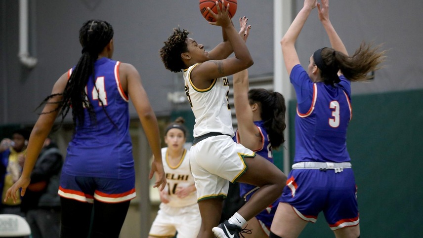 Katelyn Lewis #25 fighting through defenders on her way to a layup.