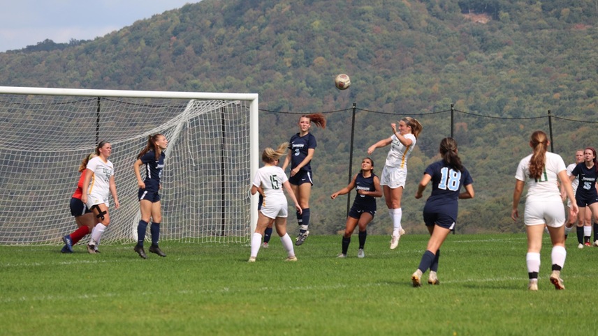 soccer players playing corner kick