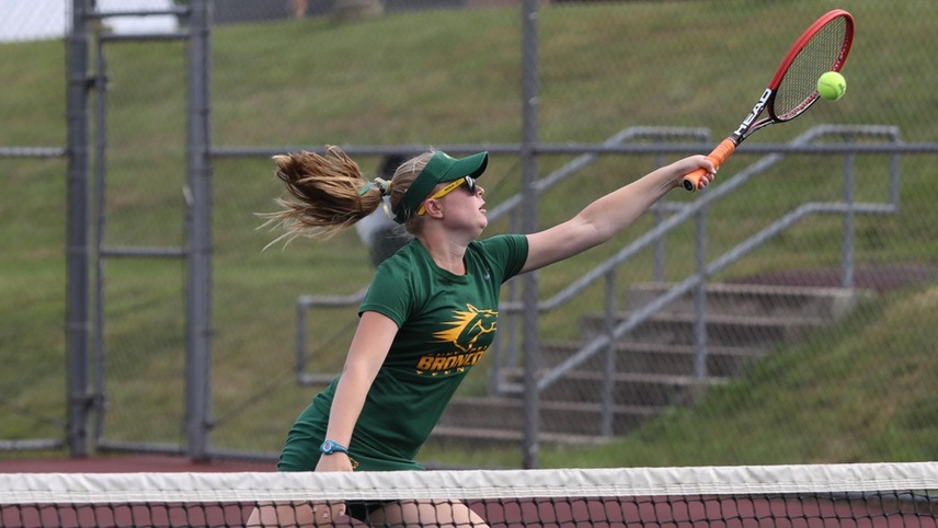 Mackenzie Landman about to return a shot in front of the net.