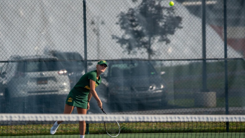 Madison Saleman sending a serve over the net.