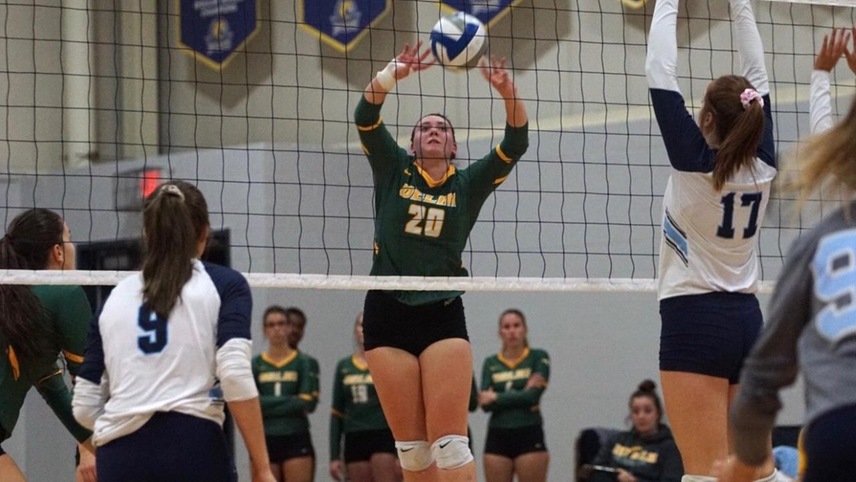 Chloe Elsenbeck hitting the ball back over the net.