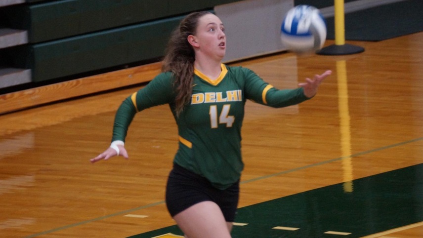 Taylor Tsatsis about to deliver a serve.